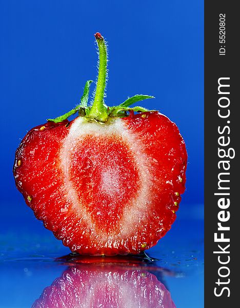 Slice of a strawberry on blue background