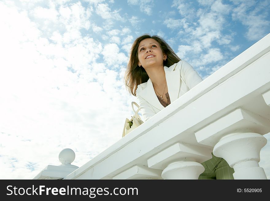 Beauty woman on historic building under blue sky with clouds