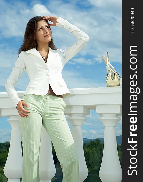 Beauty woman on historic building under blue sky with clouds