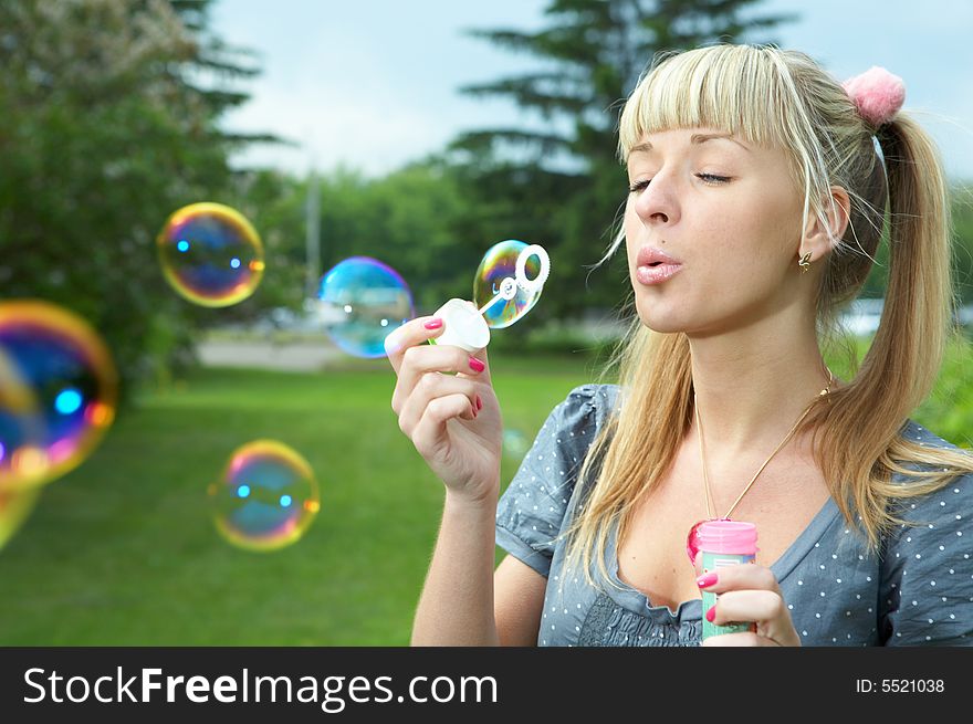 Young girl makes soap bubble