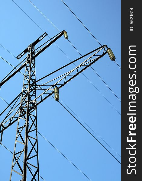 High voltage tower on blue sky