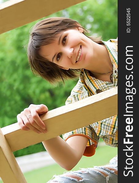 Young woman on a wooden ladder. Young woman on a wooden ladder.