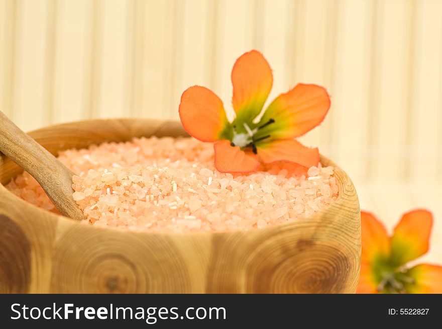 Close up on aromatic bath salt with decoration flowers