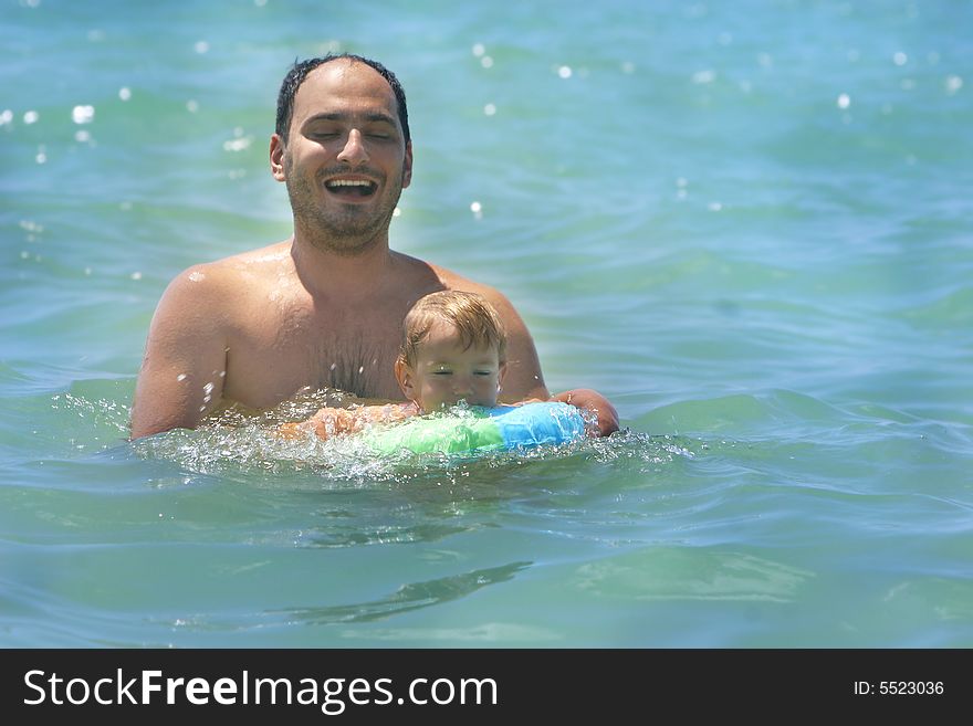 Father and son swimming in the sea