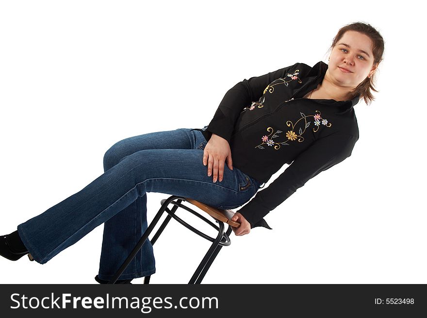 Girl sits on stool isolated on white