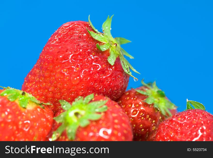 Close up on fresh strawberries on blue background