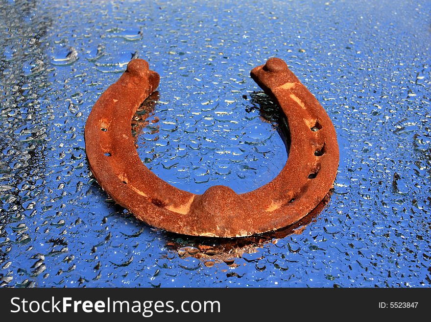 Old horseshoe on the water drops background