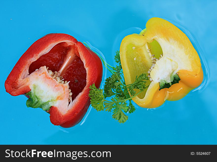 Floating fresh  peppers   with blue water background