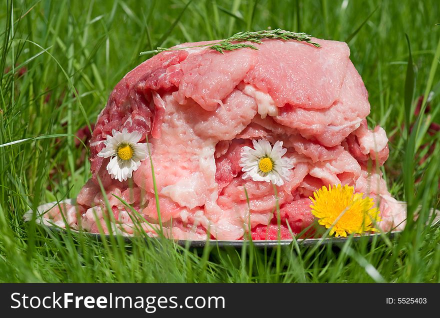 Stack of tender beef steaks with flowers and herbs