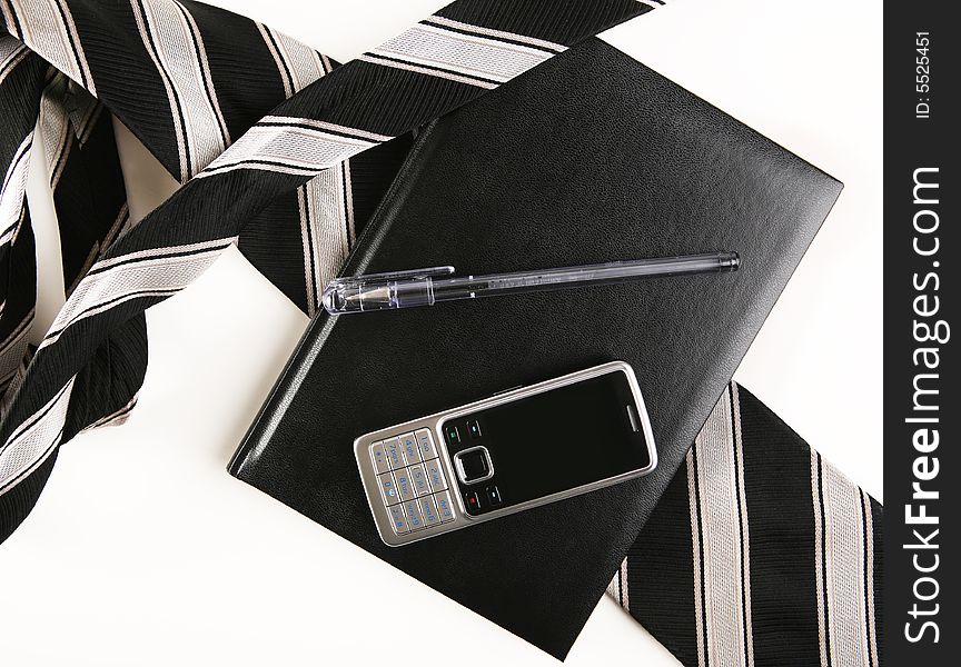 Mobile phone, organizer, pen and a mobile phone on white background. Mobile phone, organizer, pen and a mobile phone on white background