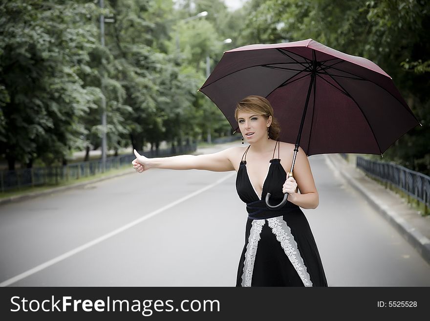 Woman Under Umbrella On The Road. Woman Under Umbrella On The Road