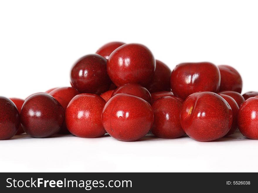 A lot of fresh red cherry with drops on background