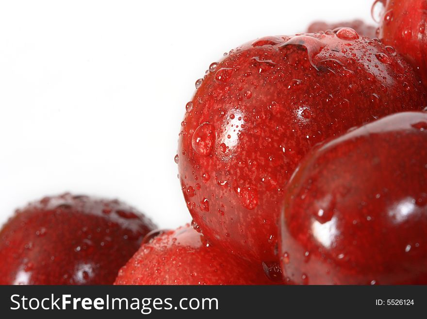 A lot of fresh red cherry with drops on background