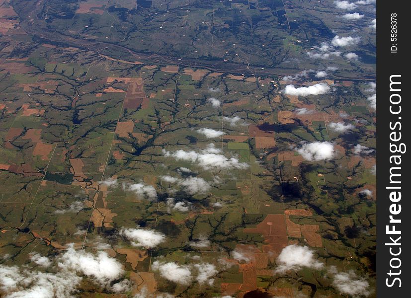 Line formation of clouds across some farmland. Line formation of clouds across some farmland.