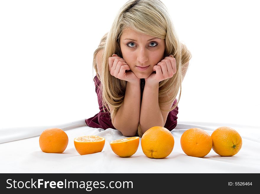 Beautiful girl thinks of oranges. Isolated over white