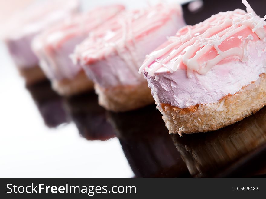 Small cakes on black plate