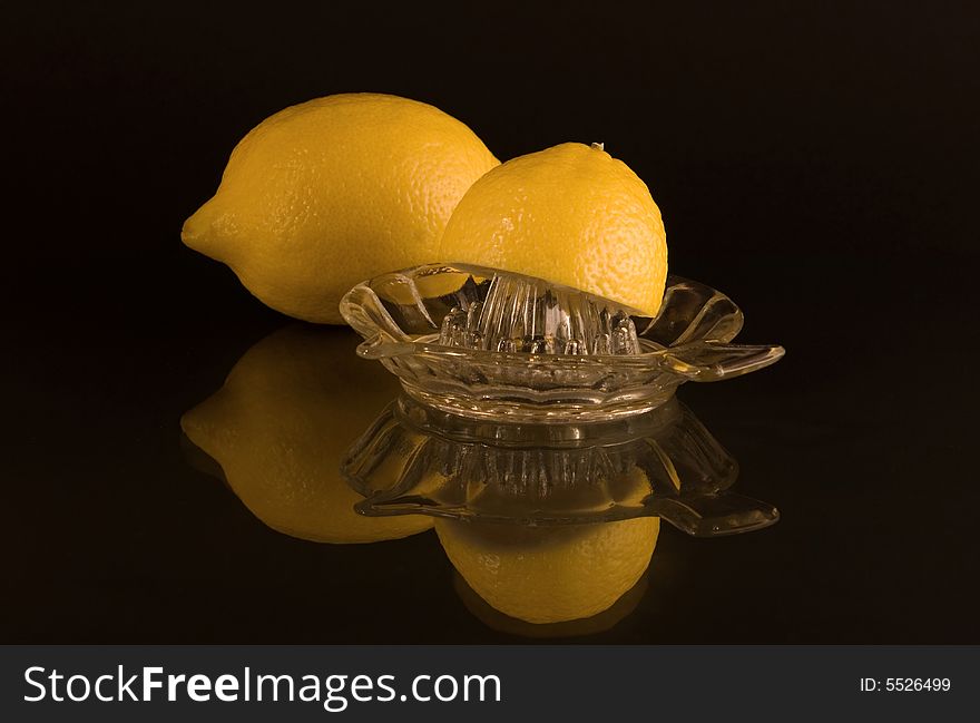 Lemon and lemon squeezer with black background