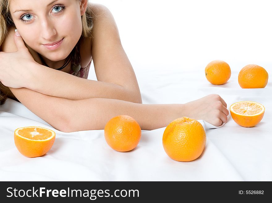 Closeup portrait of happy young woman with two orange laying on a floor. Closeup portrait of happy young woman with two orange laying on a floor