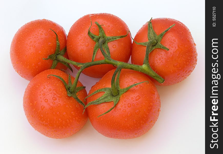 Five tomatoes on white.