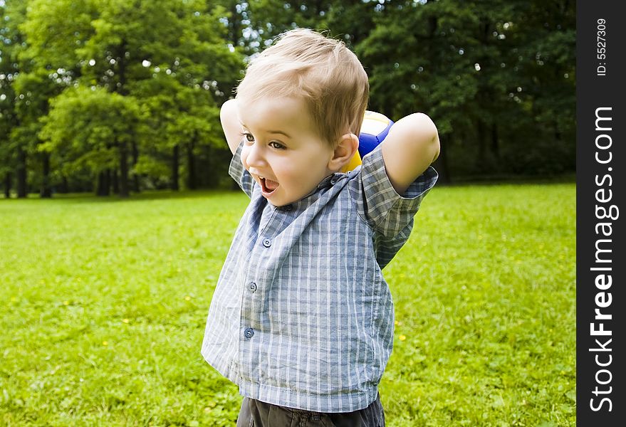 Young Baby Playing With Ball Outdoors