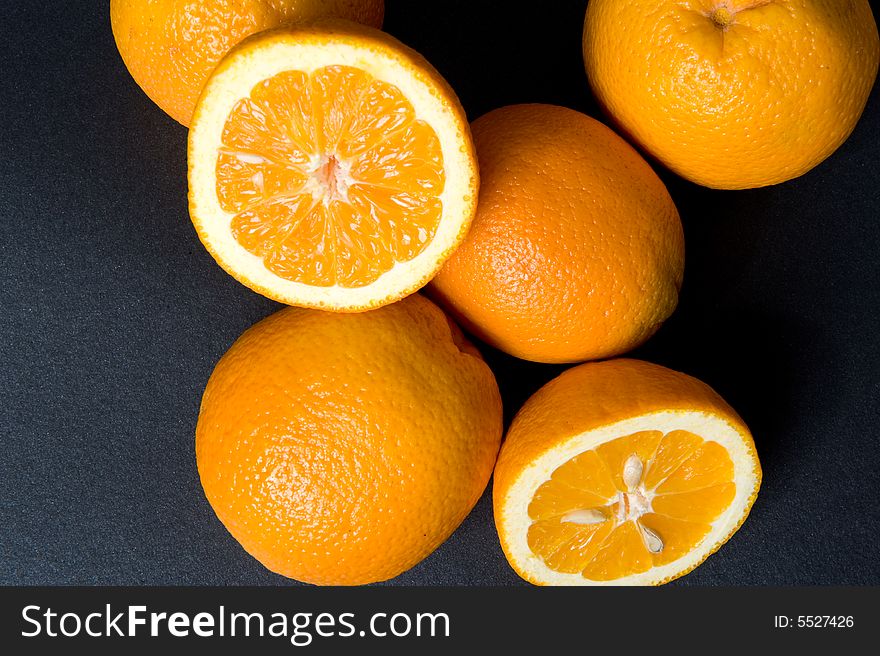 Orange fruits on the black background. Orange fruits on the black background