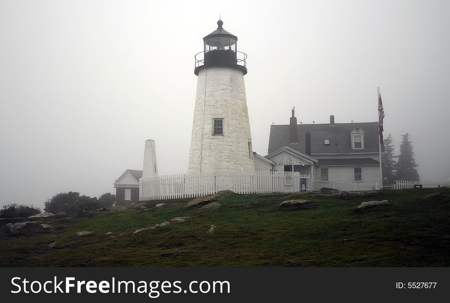 A lighthouse sitting in light fog in Maine, USA. A lighthouse sitting in light fog in Maine, USA