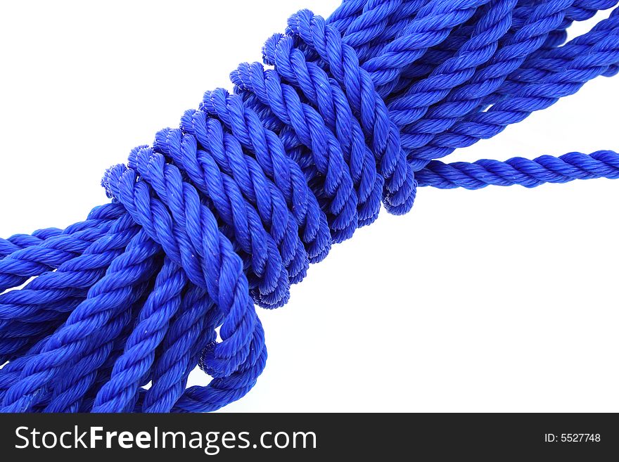 Detail of a neatly tied blue rope isolated on white