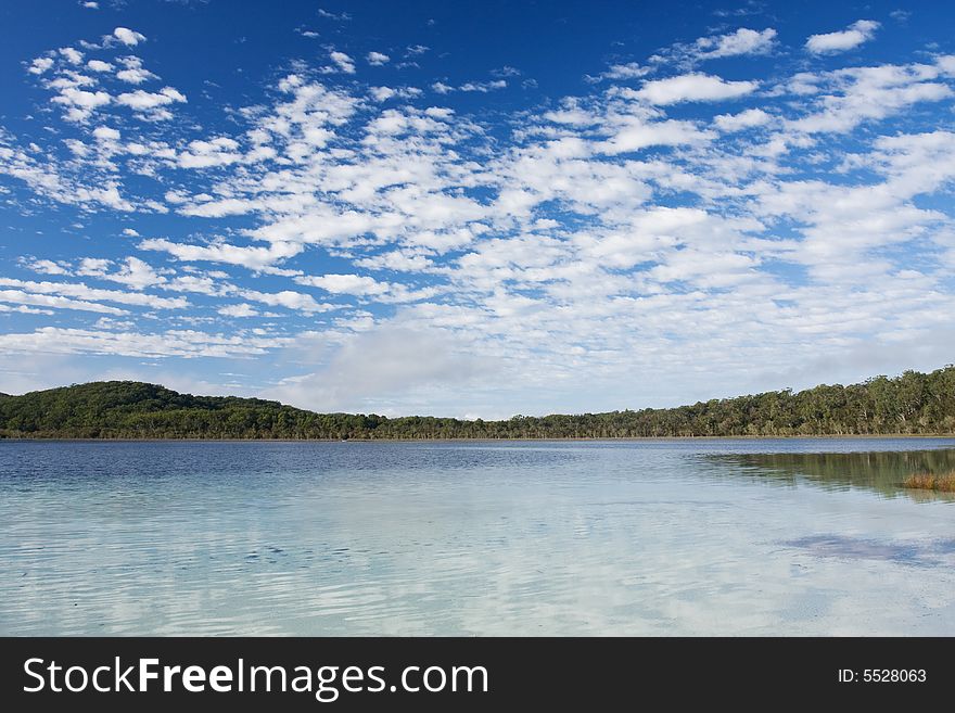 Lake McKanzie in Fraser Island and beautiful blue sky with some nice white clouds. Lake McKanzie in Fraser Island and beautiful blue sky with some nice white clouds.