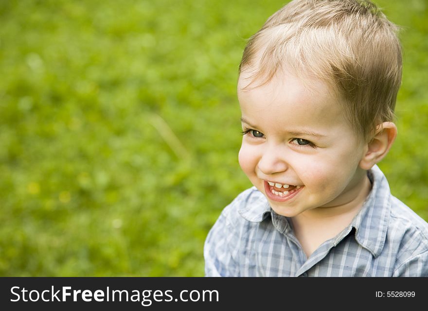 Happy Baby Boy Relaxing Outdoors