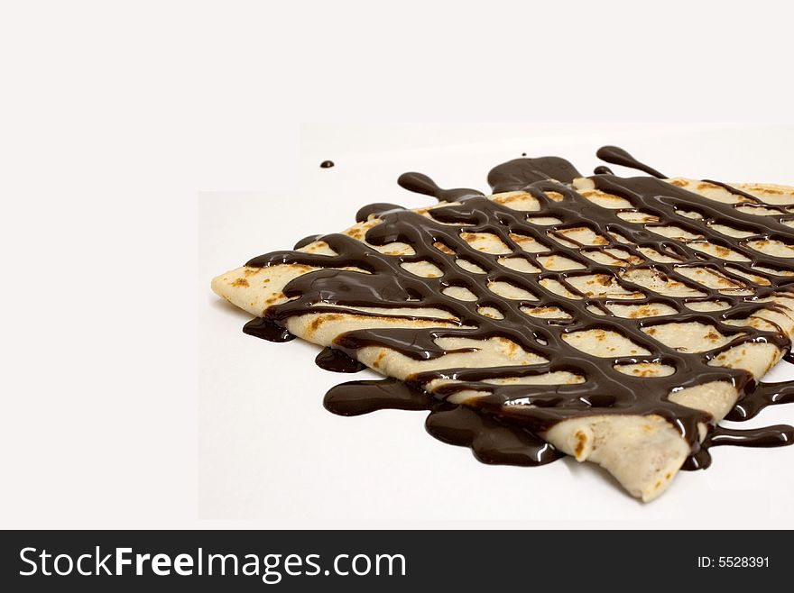A chocolate crepe isolated on a white background. A chocolate crepe isolated on a white background