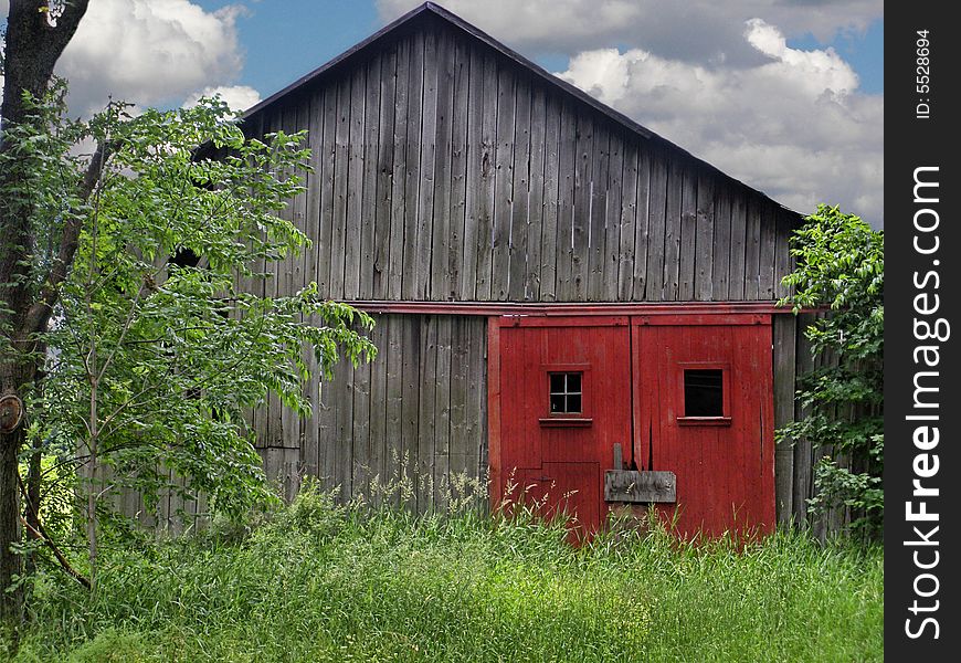 Red door on an old barn soon to be torn down. Red door on an old barn soon to be torn down.