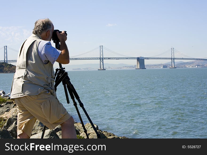 Shot of a photographer focusing his camera on San Francisco form Treasure Island.