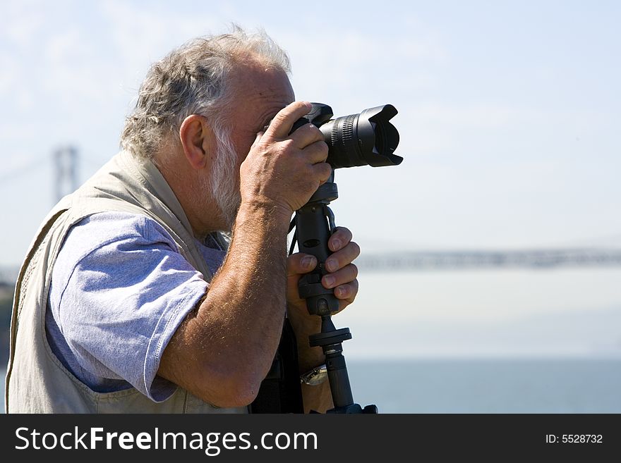 Shot of a photographer focusing his camera on San Francisco form Treasure Island.