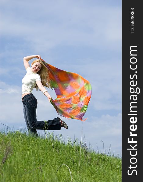 Girl with scarf stand on a wind