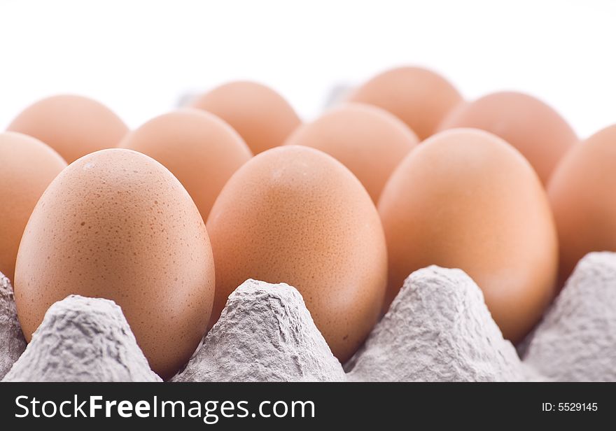 Brown eggs in cardboard container