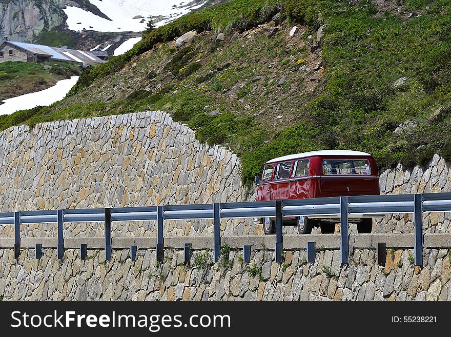 Family van going up a mountain pass in an old style. Family van going up a mountain pass in an old style