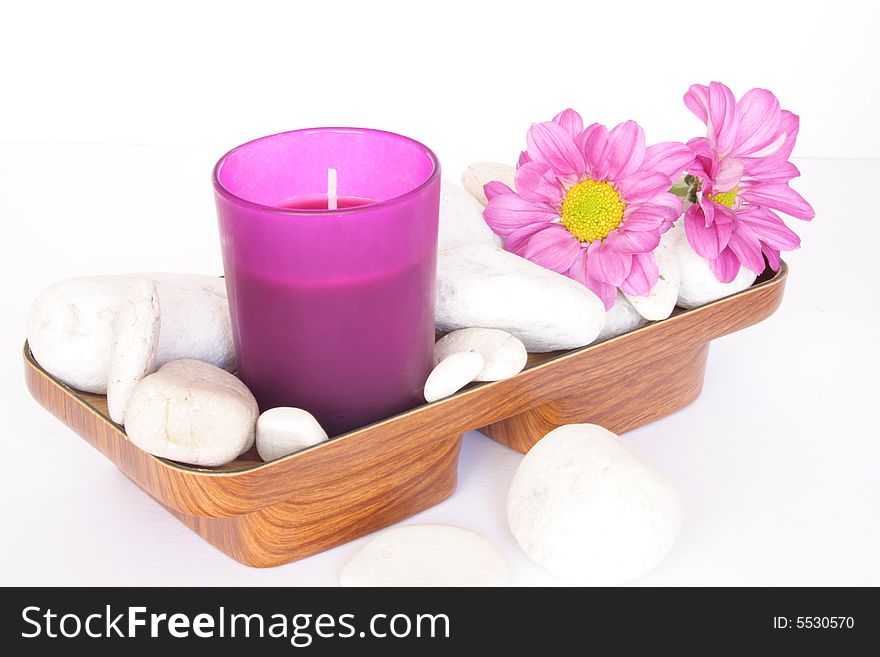 Pink candle and white pebbles with flowers. Pink candle and white pebbles with flowers