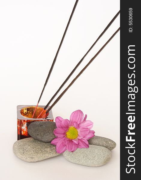 Three incense sticks and pebbles in white background. Three incense sticks and pebbles in white background