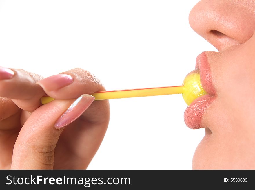 Beautiful girl sucking yellow lollipop
