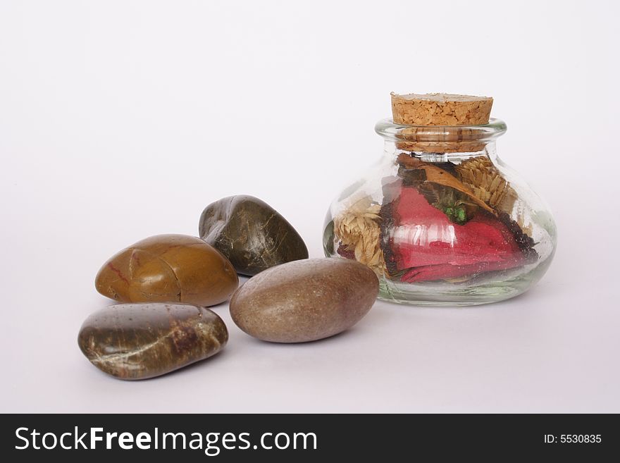Pebbles and small  bottle with scented flowers. Pebbles and small  bottle with scented flowers