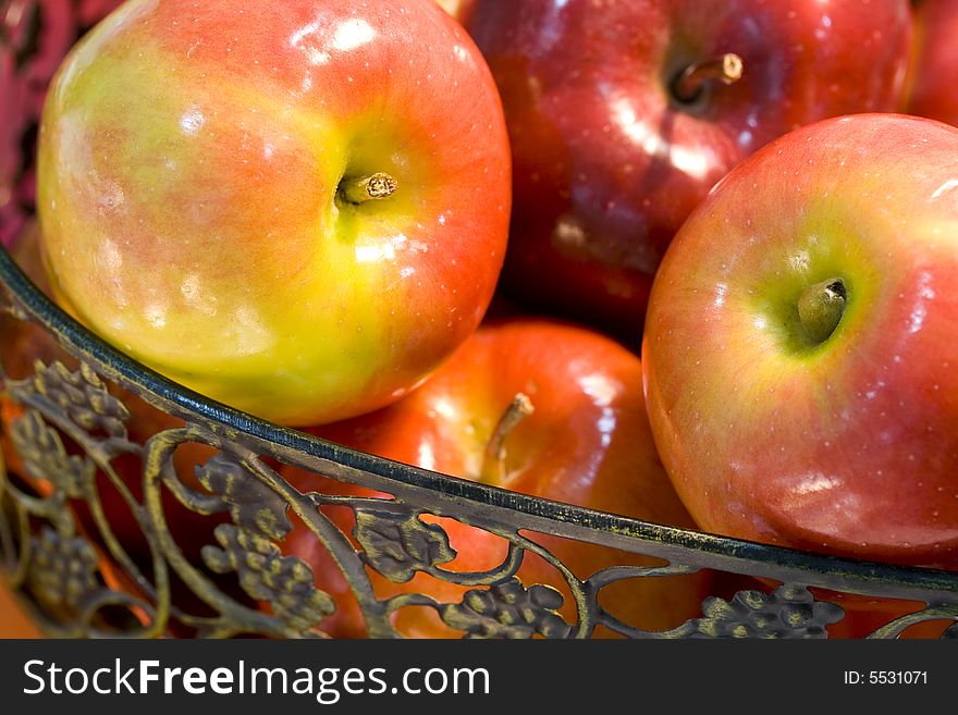 Delicious fresh red apples in wrought iron basket. Delicious fresh red apples in wrought iron basket