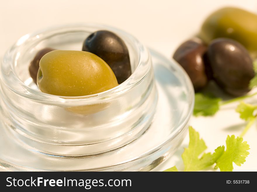 Fresh black and green olives in glass bowl