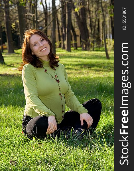 Expectant Mother On A Grass In Park