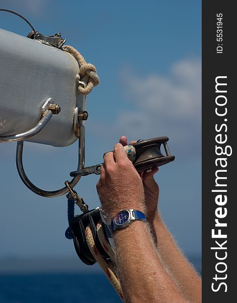 Fixing a rope on a sailboat. Fixing a rope on a sailboat