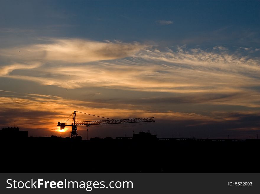 City sunset sky over a big crane. City sunset sky over a big crane