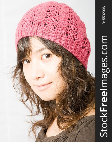 A cute asian girl wearing a pink and red hat. A cute asian girl wearing a pink and red hat.