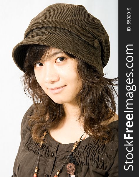 A cute asian girl wears a brown hat which fit her face and hair very well!. A cute asian girl wears a brown hat which fit her face and hair very well!