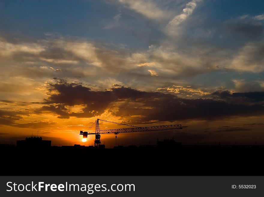 Summer sunset over city construction site. Summer sunset over city construction site