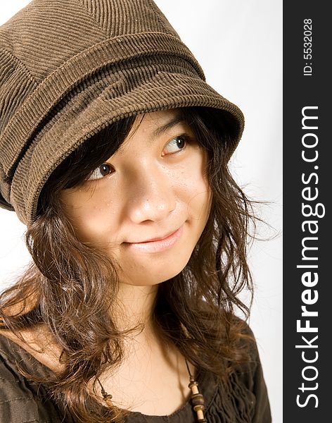 A cute asian girl wears a brown hat which fit her face and hair very well!. A cute asian girl wears a brown hat which fit her face and hair very well!