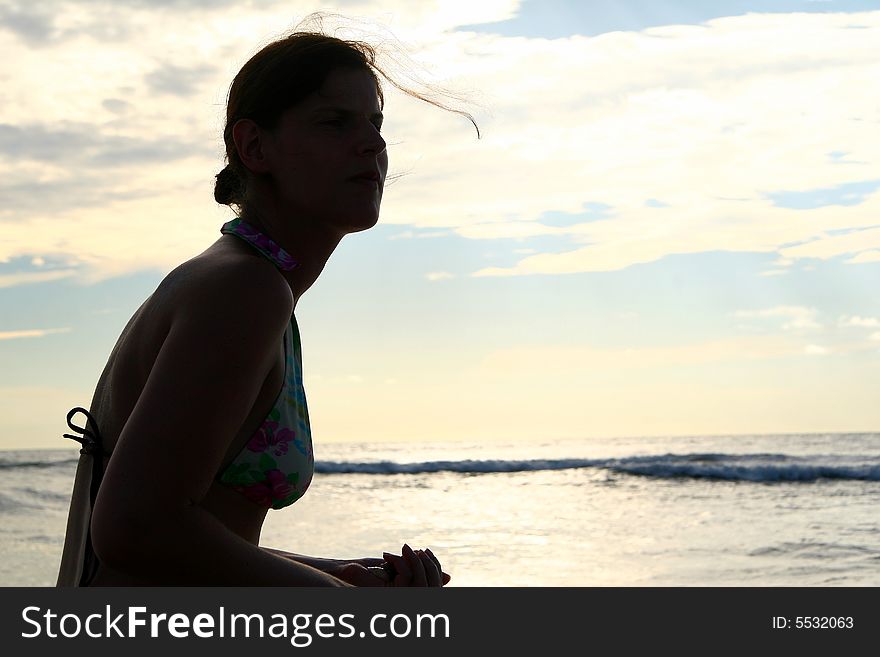 The silhouette of a young woman at the beach. Ideal vacation shot. The silhouette of a young woman at the beach. Ideal vacation shot.